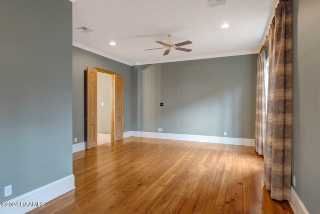 empty room with ceiling fan, hardwood / wood-style floors, and ornamental molding