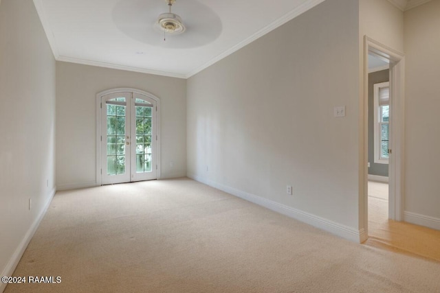 carpeted empty room with ceiling fan, french doors, and ornamental molding