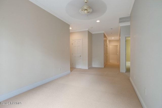 hallway featuring light carpet and ornamental molding