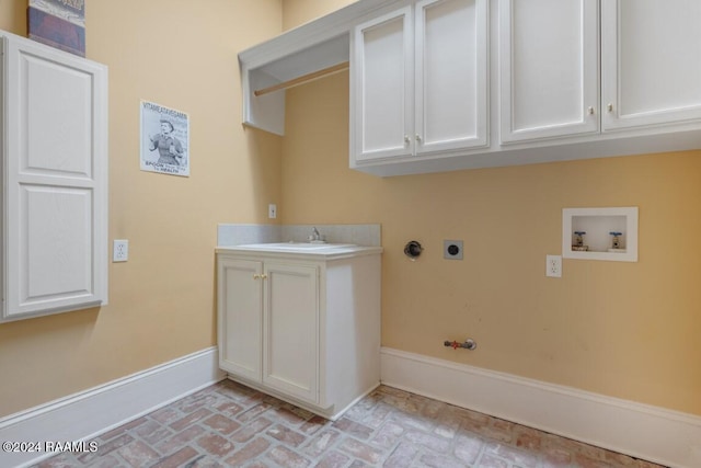 106 Kings Walk, Lafayette, LA 70503 - laundry room with brick floors, hookup for an electric dryer, washer hookup, hookup for a gas dryer, and cabinet space
