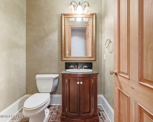 bathroom featuring toilet and vanity