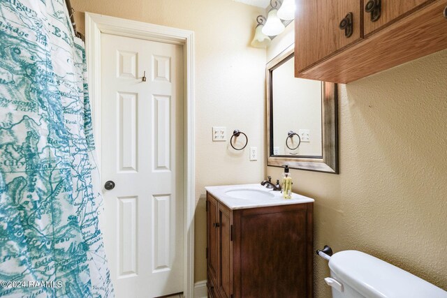 100 Teal Ln Unit 21, Lafayette, LA 70507 - bathroom featuring toilet, vanity, and a shower with curtain