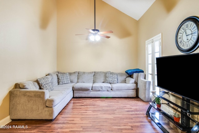 living room with hardwood / wood-style flooring, ceiling fan, and high vaulted ceiling