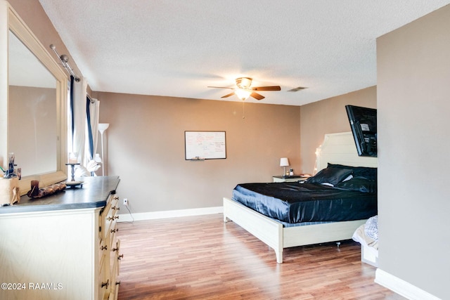 100 Teal Ln Unit 21, Lafayette, LA 70507 - bedroom featuring light wood-style flooring, a textured ceiling, baseboards, and a ceiling fan