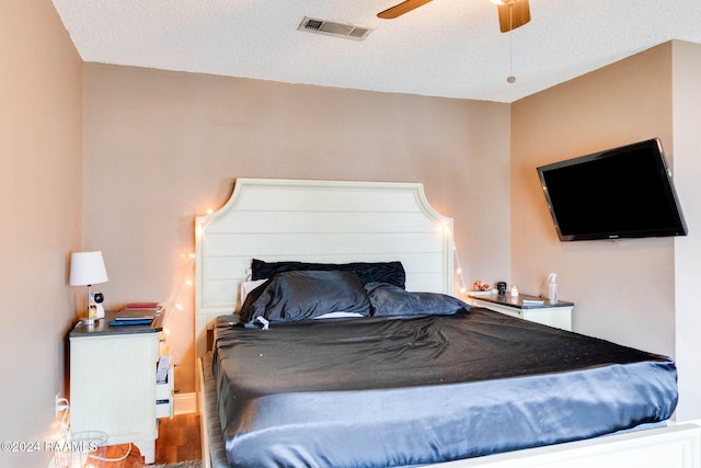 100 Teal Ln Unit 21, Lafayette, LA 70507 - bedroom featuring a textured ceiling, wood finished floors, and a ceiling fan