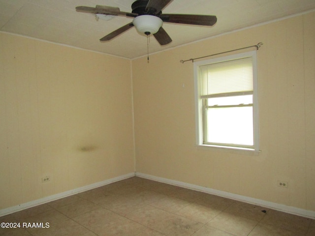 tiled spare room with ceiling fan