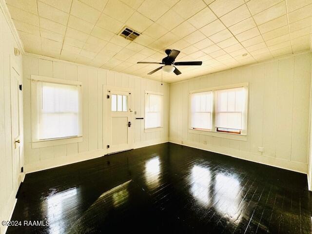 empty room with ceiling fan and wood-type flooring