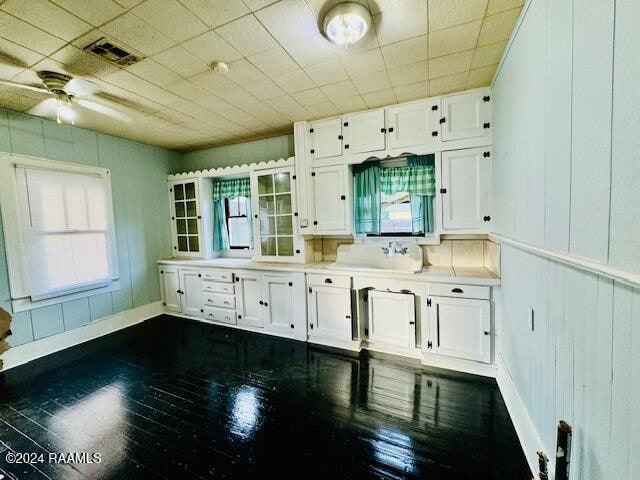 kitchen featuring white cabinetry, ceiling fan, and dark wood-type flooring