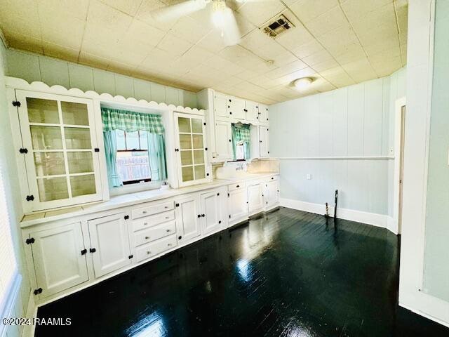 kitchen featuring white cabinets and ceiling fan