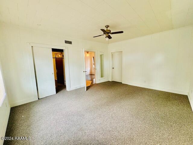 unfurnished bedroom featuring carpet and ceiling fan