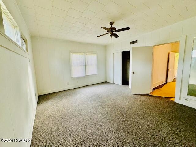 unfurnished room featuring carpet floors and ceiling fan