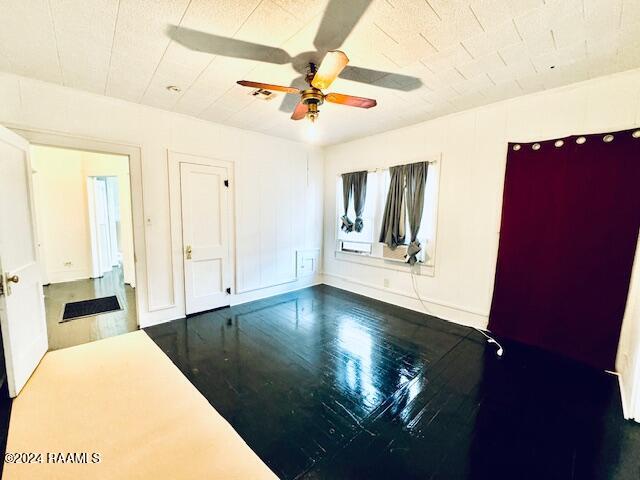 empty room featuring hardwood / wood-style floors and ceiling fan