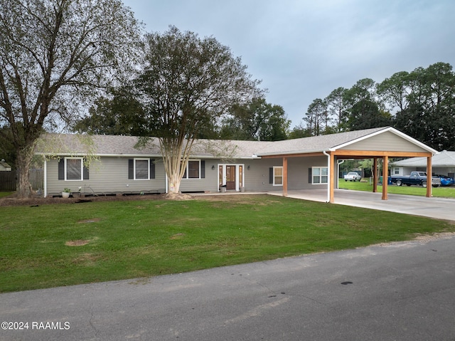 ranch-style home featuring a front lawn and a carport