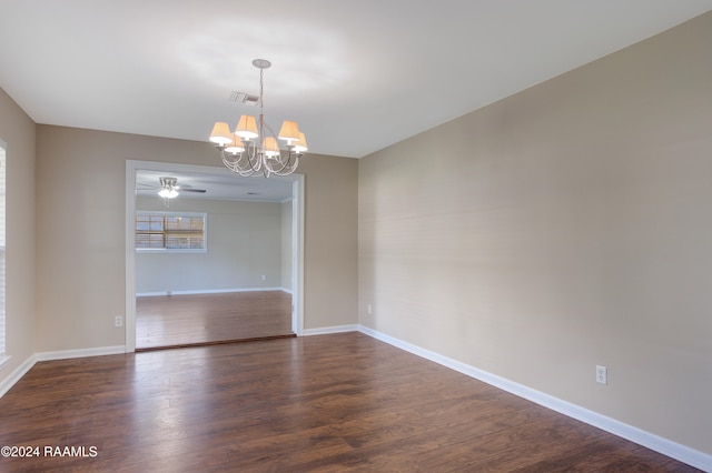 unfurnished room featuring dark hardwood / wood-style floors and ceiling fan with notable chandelier