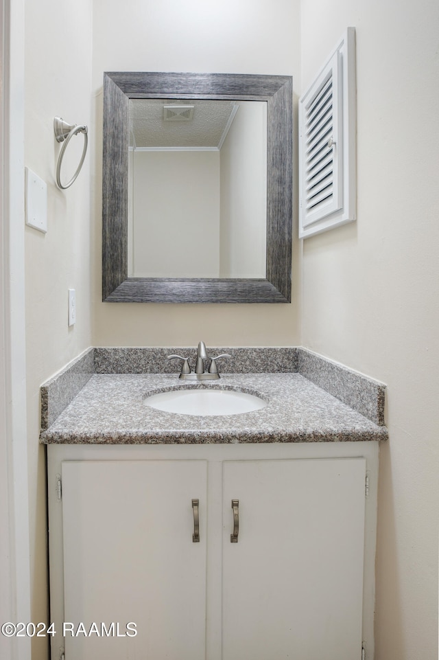 bathroom with vanity and a textured ceiling