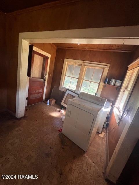 misc room with washer and dryer and wooden walls