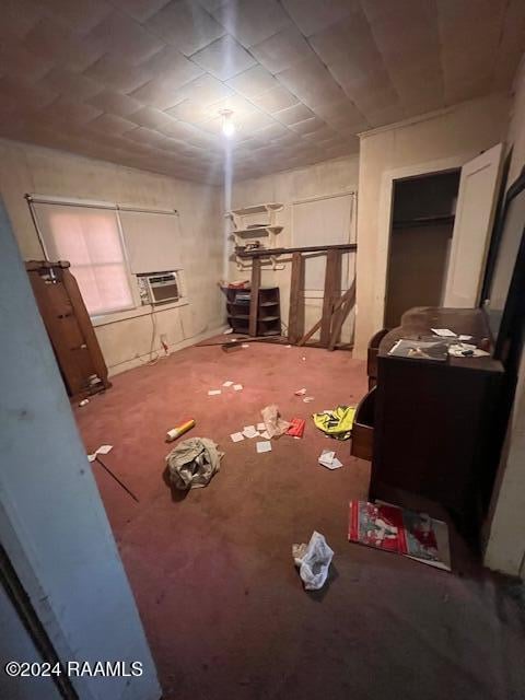 interior space featuring a wall mounted air conditioner and carpet flooring