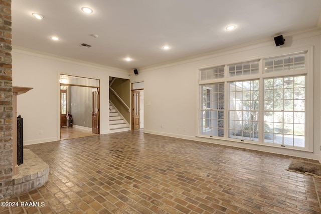 unfurnished living room with a fireplace and crown molding