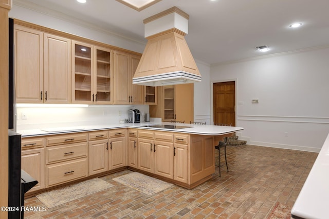 kitchen featuring black electric cooktop, light brown cabinetry, kitchen peninsula, and ornamental molding