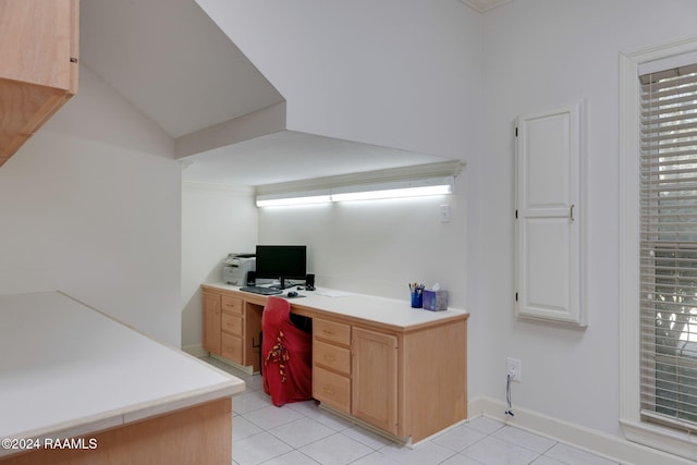 office with built in desk and light tile patterned floors