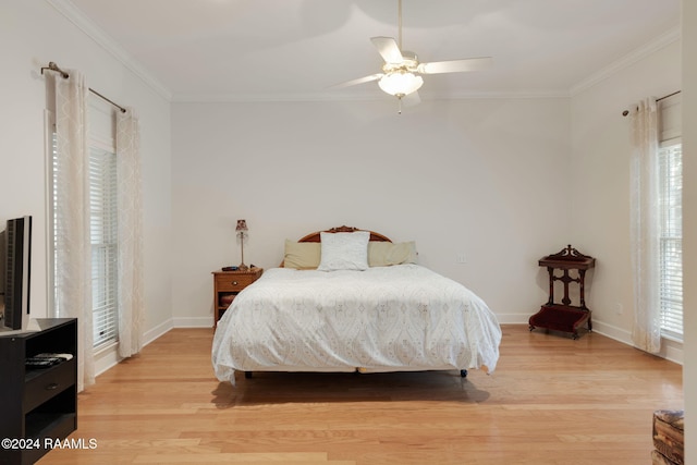 bedroom featuring crown molding, light wood-type flooring, multiple windows, and ceiling fan