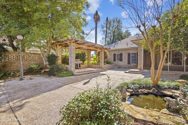 back of house with a pergola