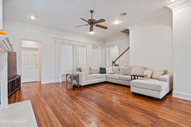 living room featuring ceiling fan, dark hardwood / wood-style floors, and crown molding