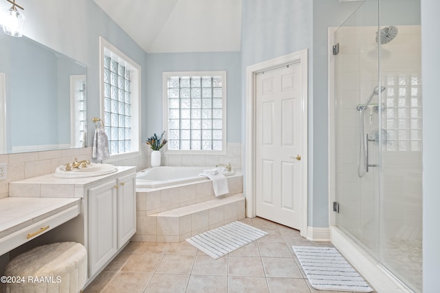 bathroom with vanity, shower with separate bathtub, lofted ceiling, and tile patterned floors