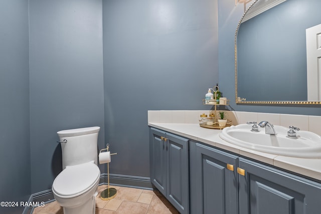 bathroom featuring toilet, vanity, and tile patterned floors