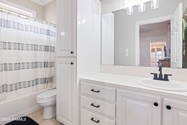 full bathroom with tile patterned flooring, ornamental molding, shower / tub combo with curtain, vanity, and toilet