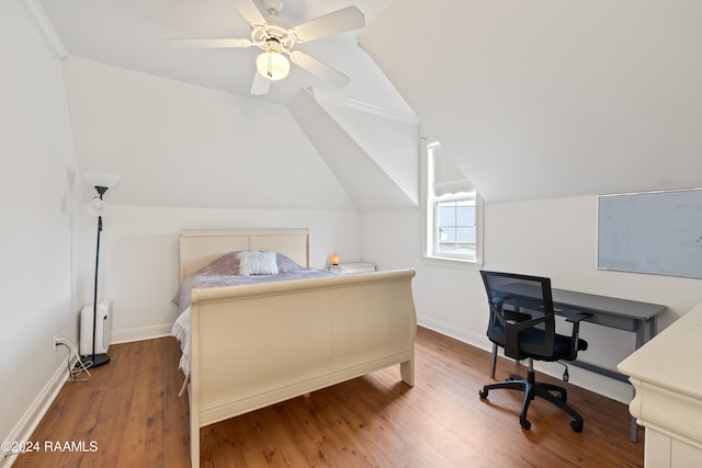 bedroom featuring hardwood / wood-style floors, vaulted ceiling, and ceiling fan