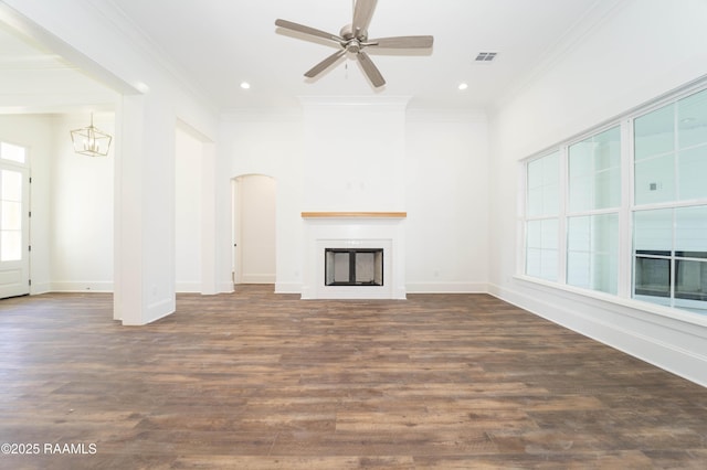 unfurnished living room featuring baseboards, visible vents, ornamental molding, wood finished floors, and a fireplace