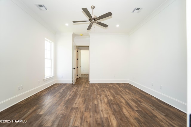 empty room with ornamental molding, visible vents, and baseboards