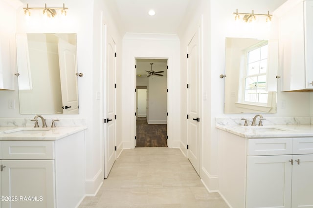 full bathroom featuring two vanities, a sink, and recessed lighting