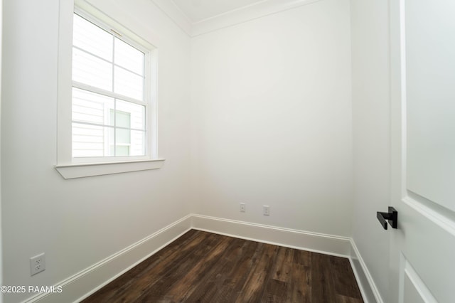 unfurnished room featuring ornamental molding, dark wood finished floors, and baseboards