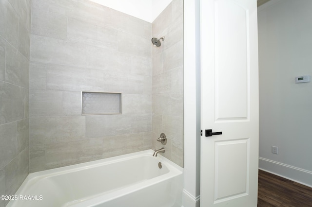 full bathroom featuring shower / bathing tub combination, baseboards, and wood finished floors