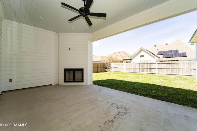 view of patio with a fenced backyard and a ceiling fan