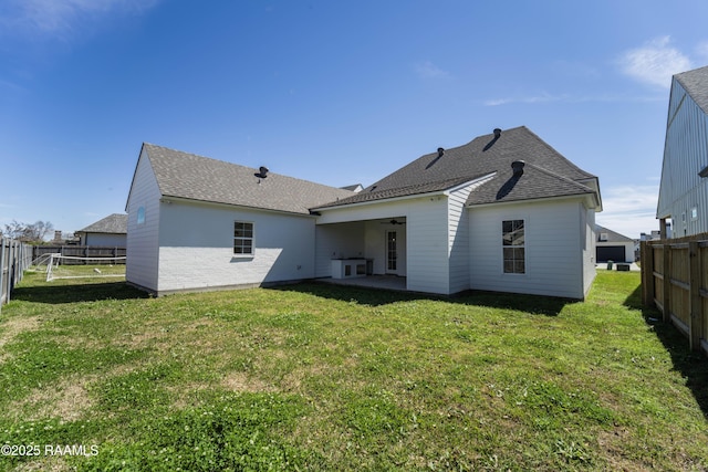 back of house with ceiling fan, a patio, a lawn, and a fenced backyard