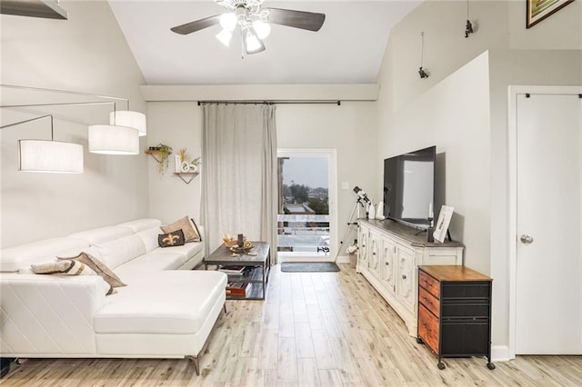 living area with lofted ceiling, baseboards, ceiling fan, and light wood finished floors