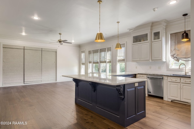 kitchen featuring dishwasher, white cabinets, sink, and light wood-type flooring