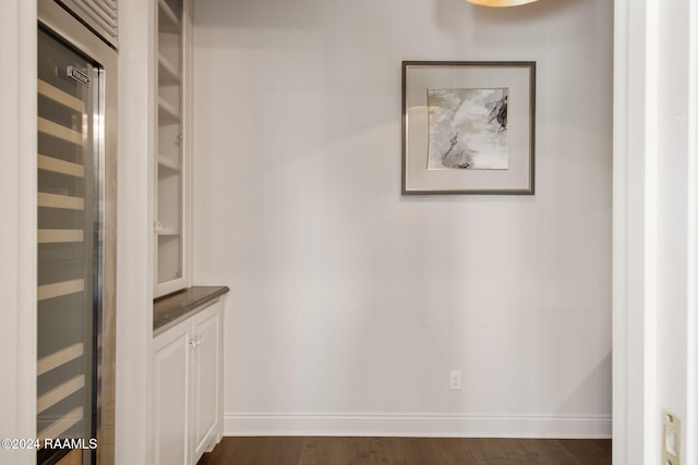 hall with dark wood-type flooring and wine cooler