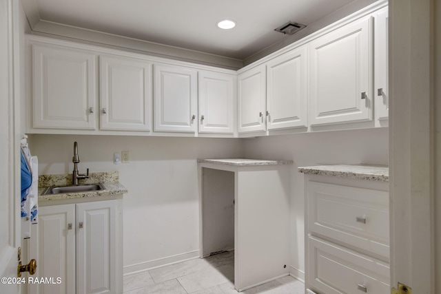 laundry room with light tile patterned floors and sink