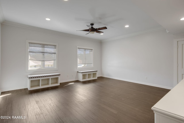 unfurnished living room featuring crown molding and dark wood-type flooring