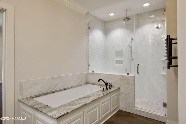 bathroom featuring ornamental molding, shower with separate bathtub, and hardwood / wood-style flooring