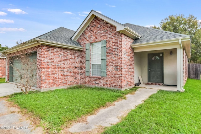 view of front of home with a front lawn and a garage