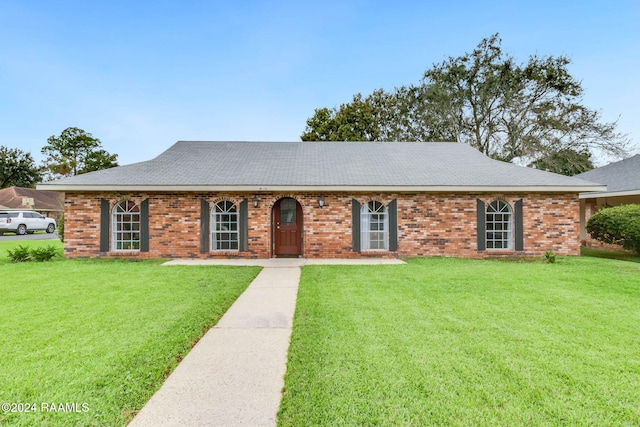 ranch-style home with a front lawn