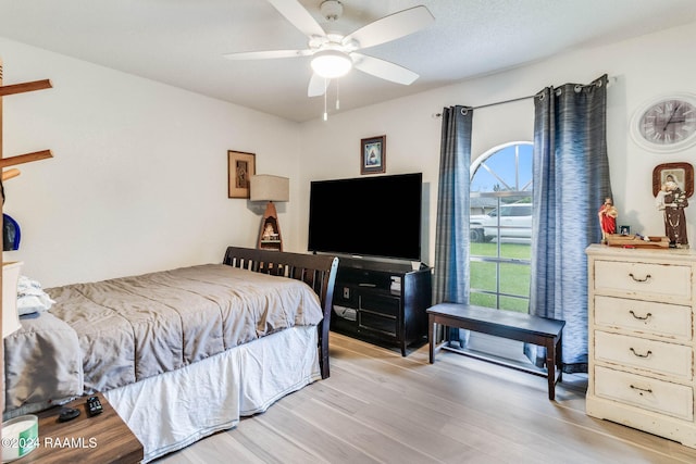 bedroom with light hardwood / wood-style floors and ceiling fan