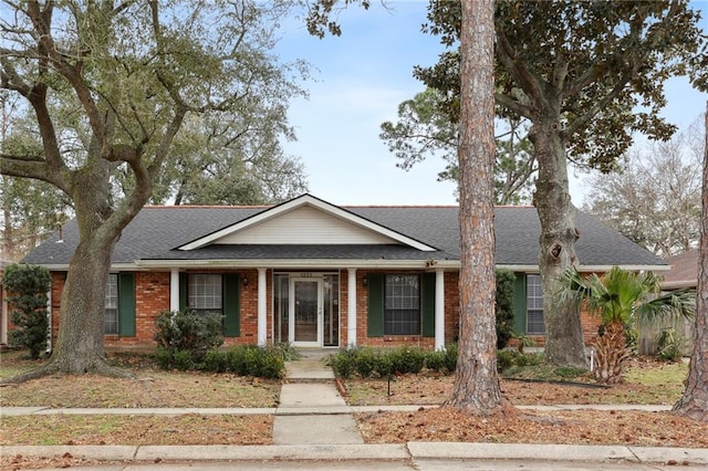 single story home with brick siding and roof with shingles