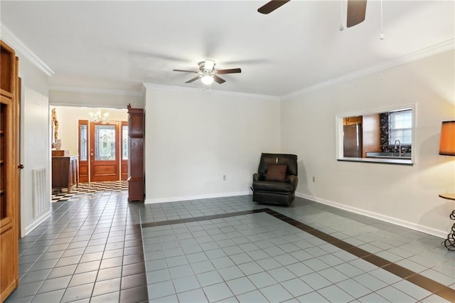 unfurnished room with tile patterned flooring, ceiling fan with notable chandelier, baseboards, and ornamental molding