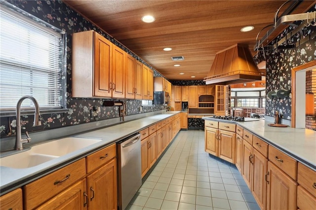 kitchen with wallpapered walls, visible vents, appliances with stainless steel finishes, custom exhaust hood, and a sink